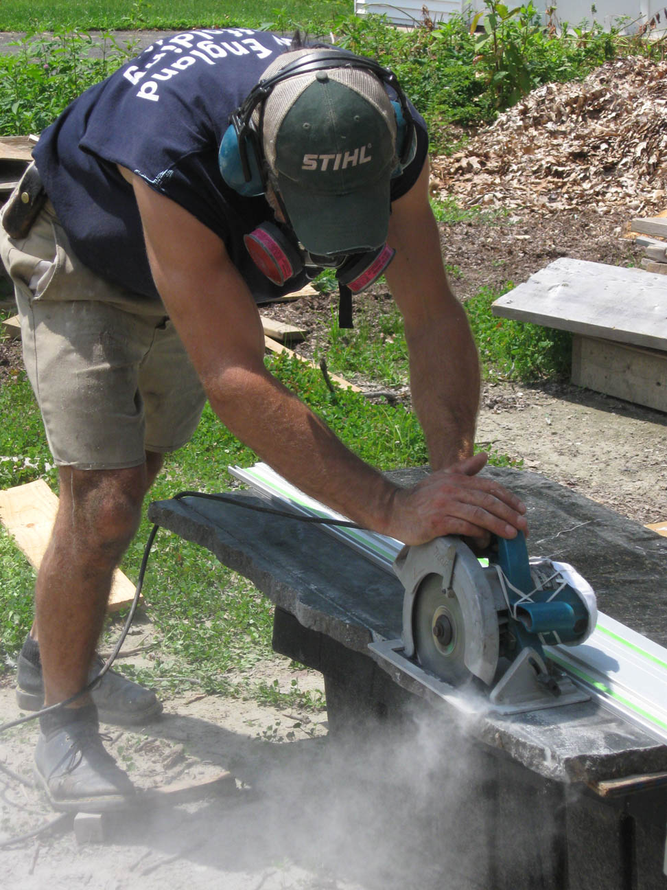 Cutting granite stone threshold - dusty.